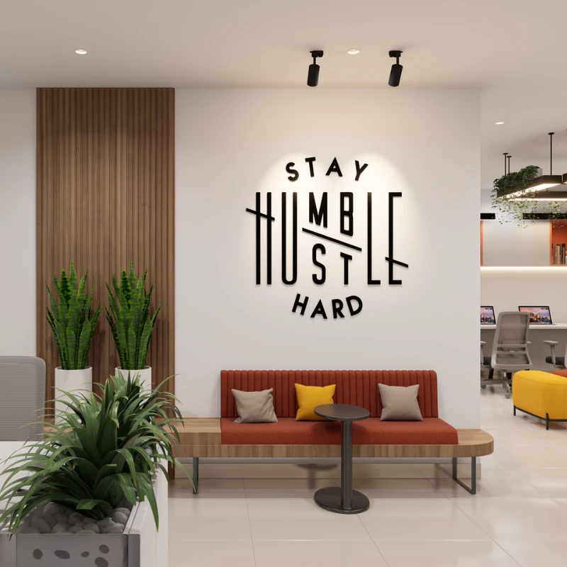 Office lounge with red cushions and motivational wall lettering