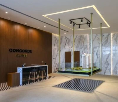 Reception lobby with marble-patterned panels and pendant lighting, Mustardd Spaces interior design portfolio