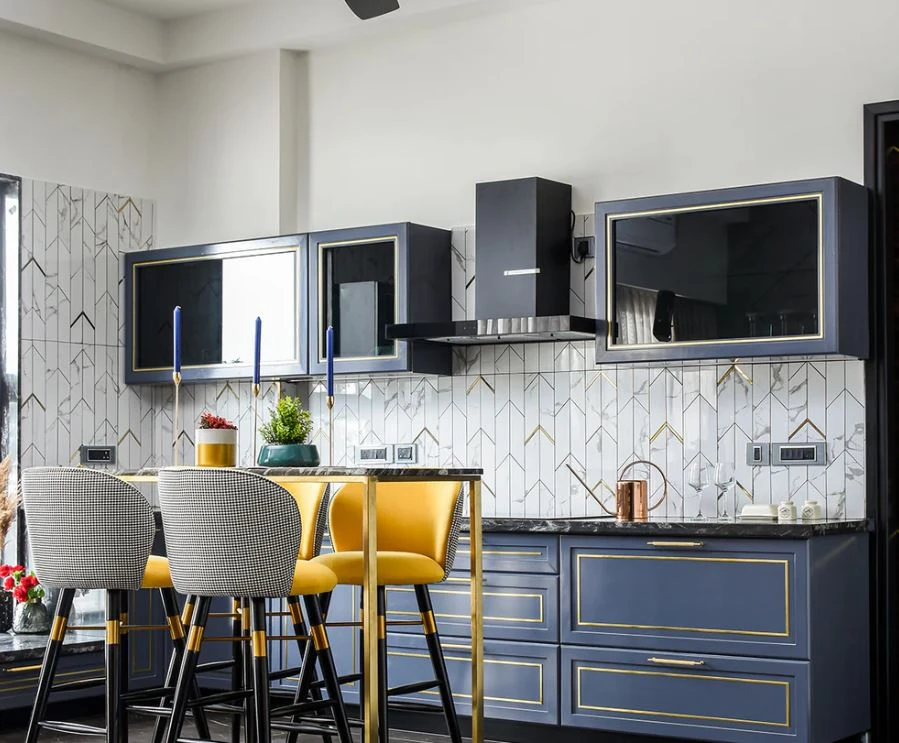 Kitchen and dining counter with blue cabinetry and yellow chairs, Mustardd Spaces interior design portfolio