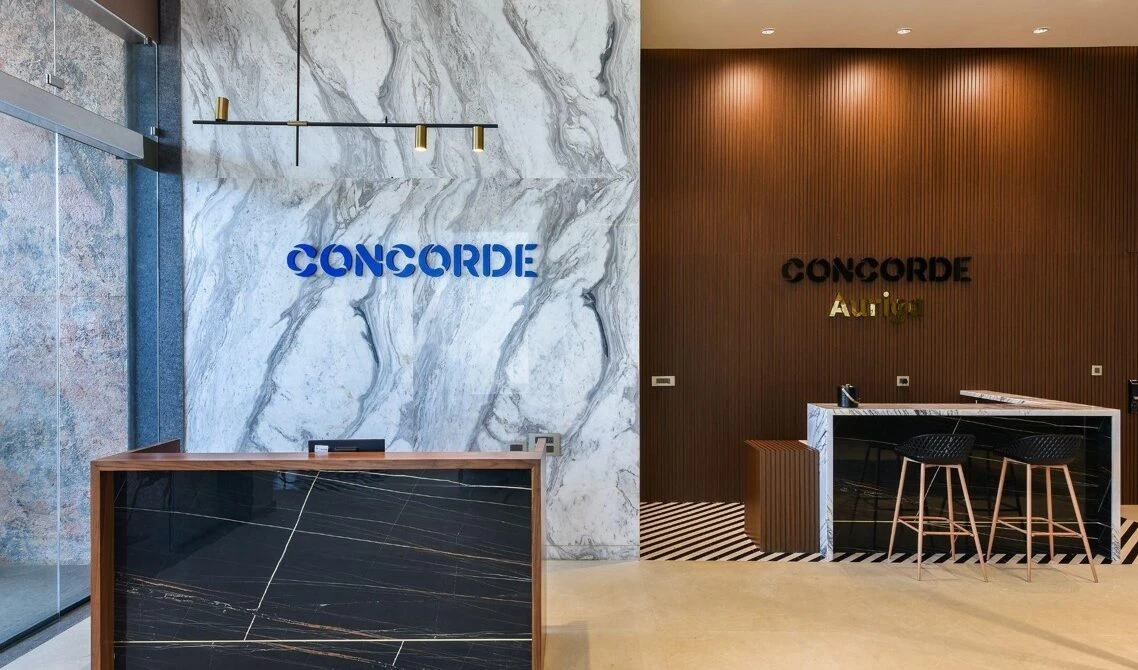 Reception counters with marble-patterned and timber wall panels, commercial interior design in Raipur