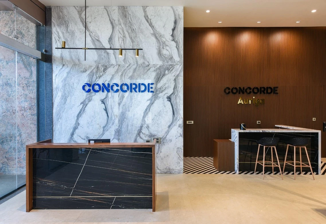 Reception counters with marble-patterned and timber wall panels, Mustardd Spaces interior design portfolio