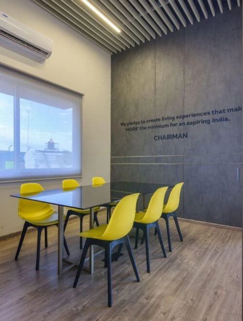 Office pantry with yellow chairs and a dining table, Mustardd Spaces interior design portfolio