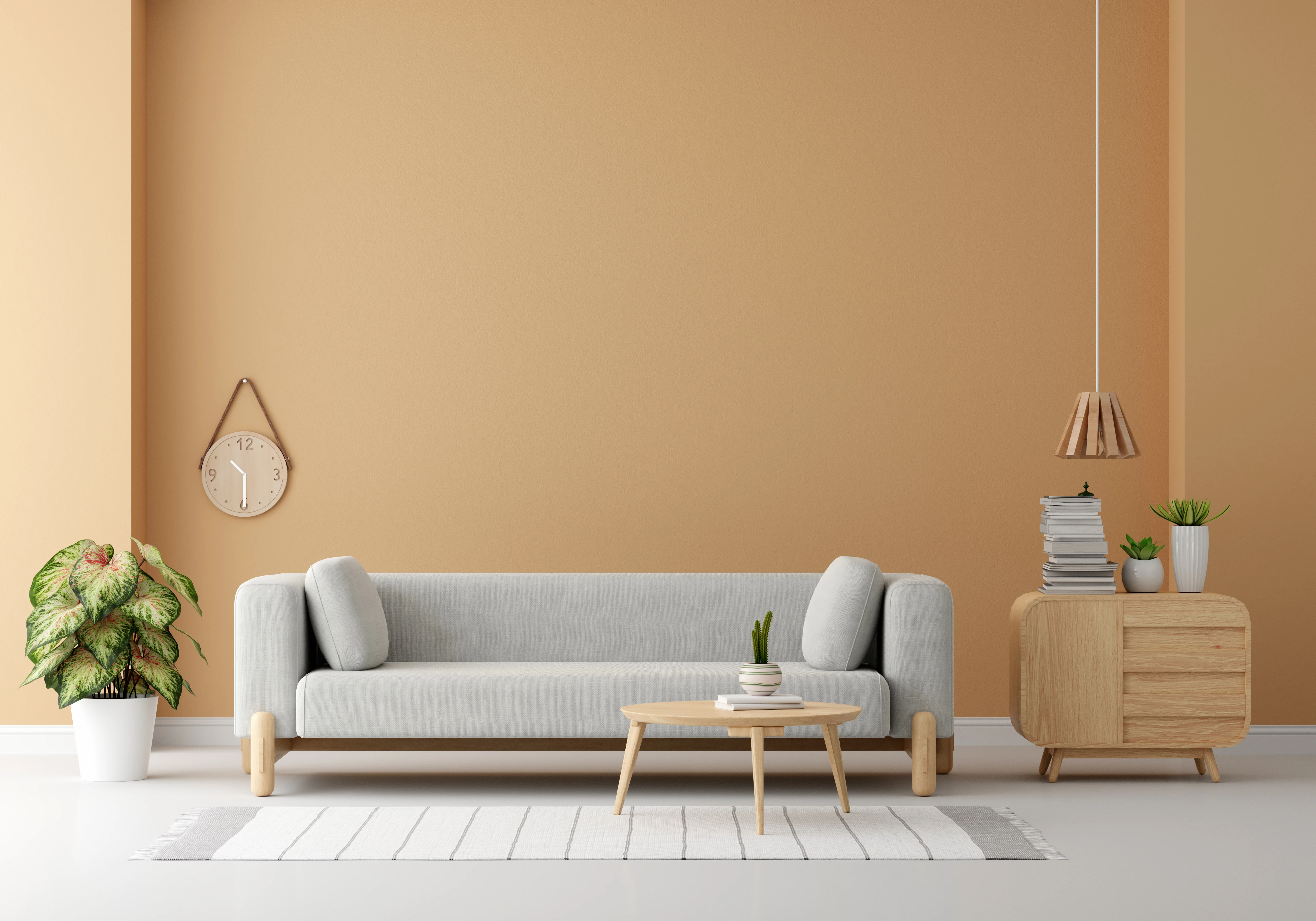 Grey sofa against a warm tan living-room wall, interior design consultation in Bhilai and Raipur