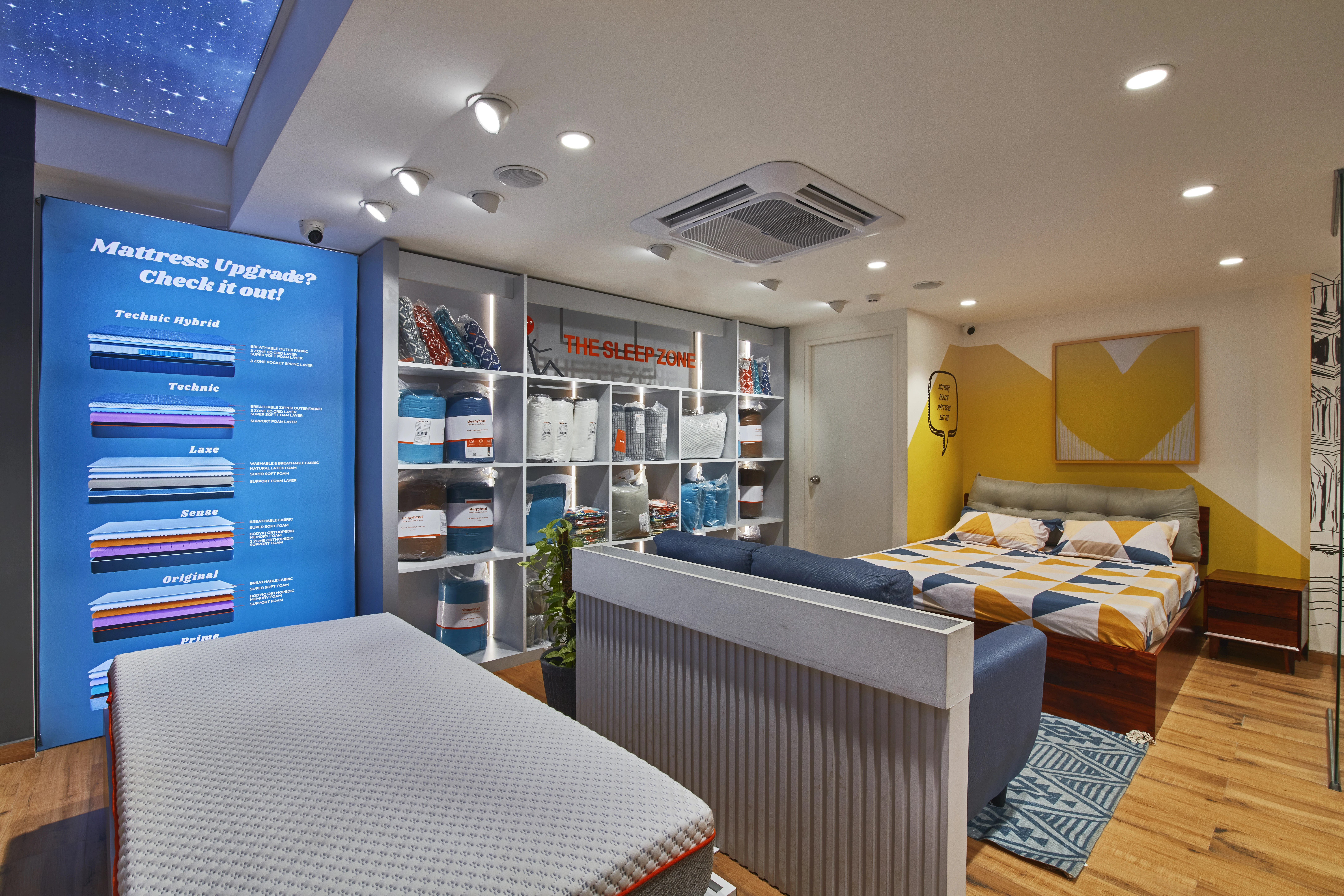 Mattress and bed displays in a furniture showroom, Sleepy Head retail interior design project in Bangalore by Mustardd Spaces