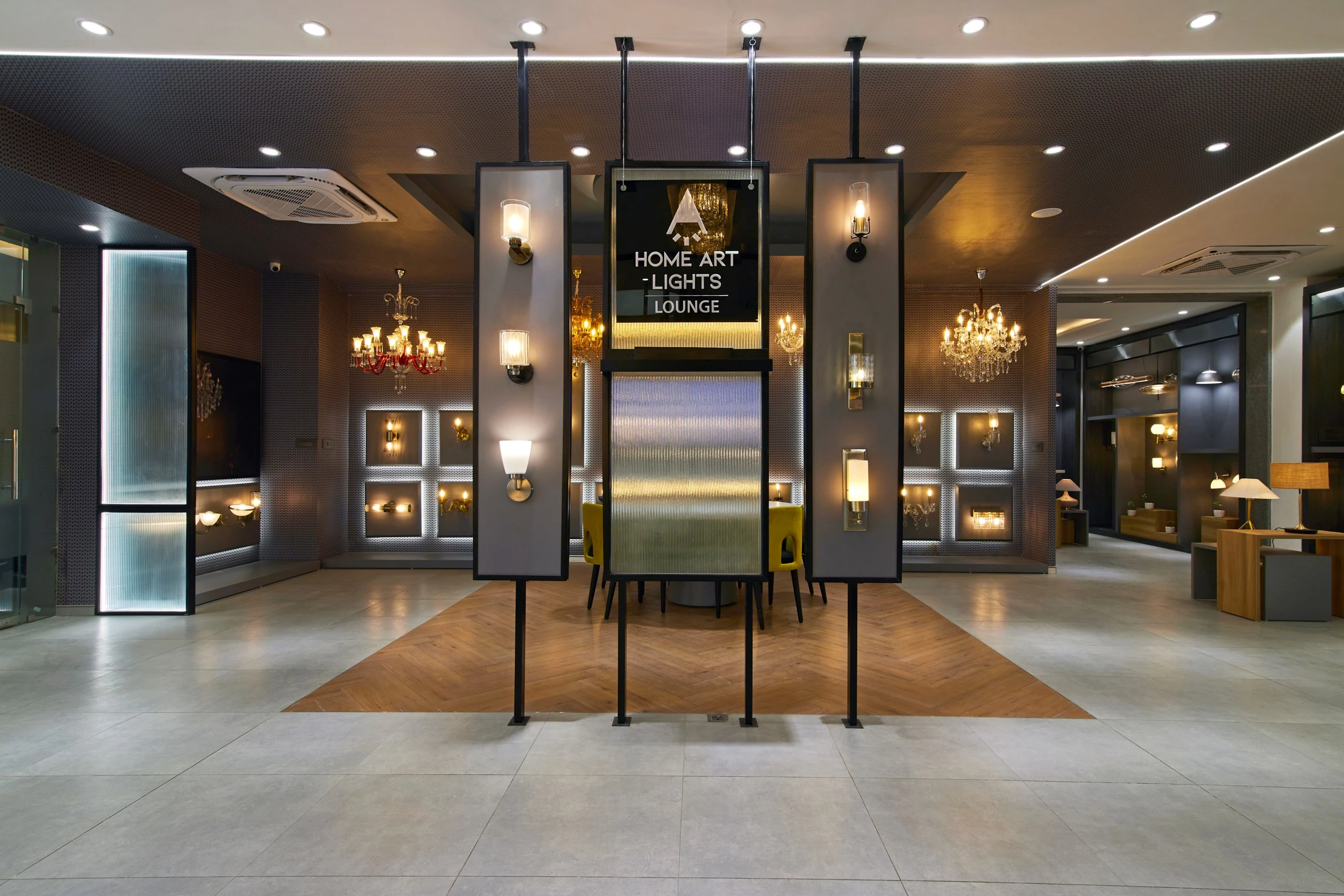 Lighting display wall with wall-mounted and pendant lamps, Havells Experience Centre retail interior design project in Gurgaon by Mustardd Spaces